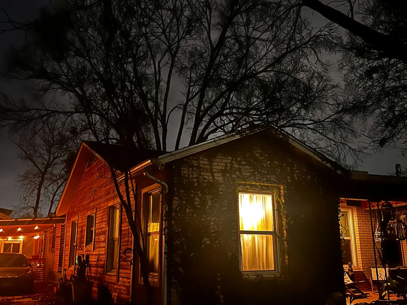 A house at night with one window lit